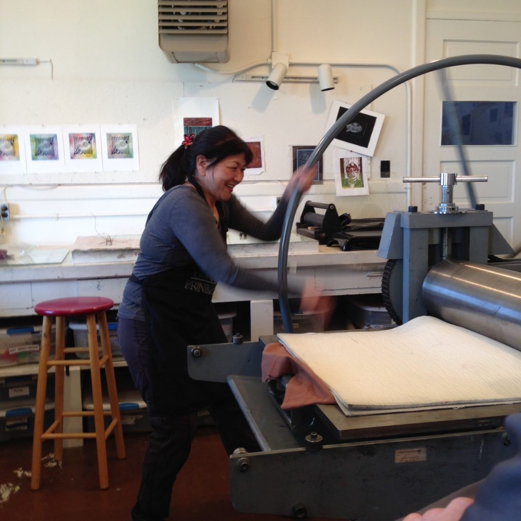 Member using the Whelan Press, A fine art printmaking press that is a redesign of 500-year-old printmaking technology and can accommodate etching, intaglio printing and lithography press processes.